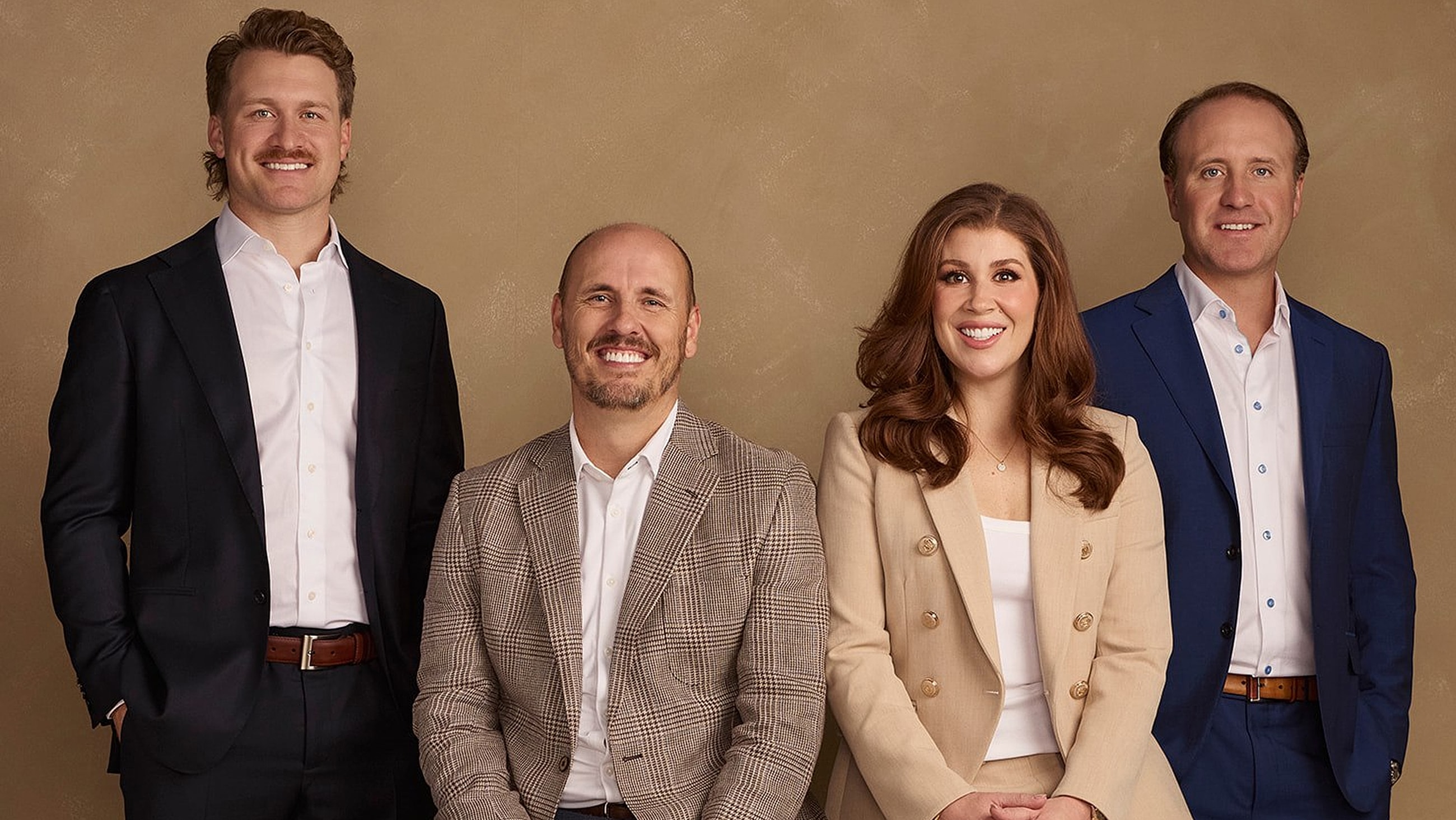 Four professionals posing for a group portrait.