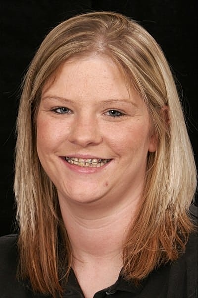 Smiling woman with long, light brown hair.