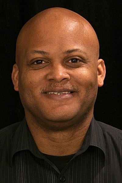 Smiling man with bald head and mustache