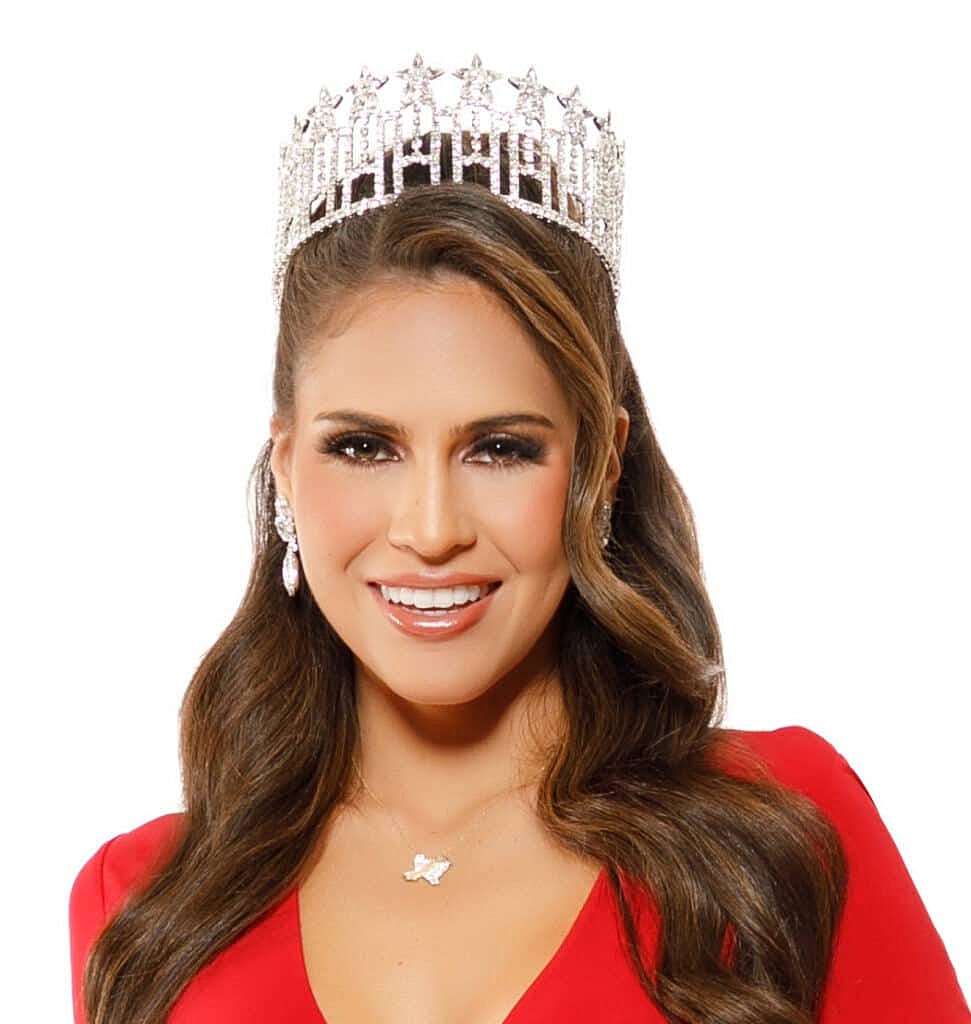 Woman wearing crown and red dress, smiling.