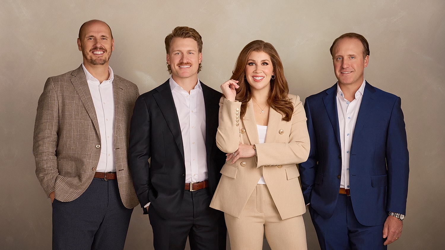 Professional group portrait of four individuals.