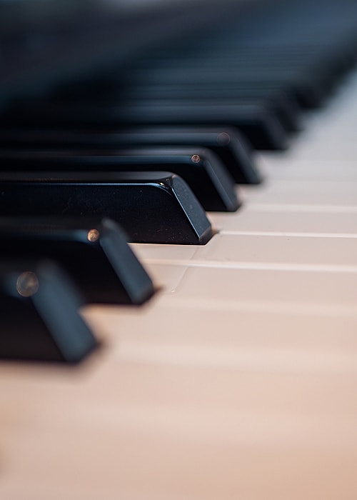 Close-up of piano keys in soft lighting.