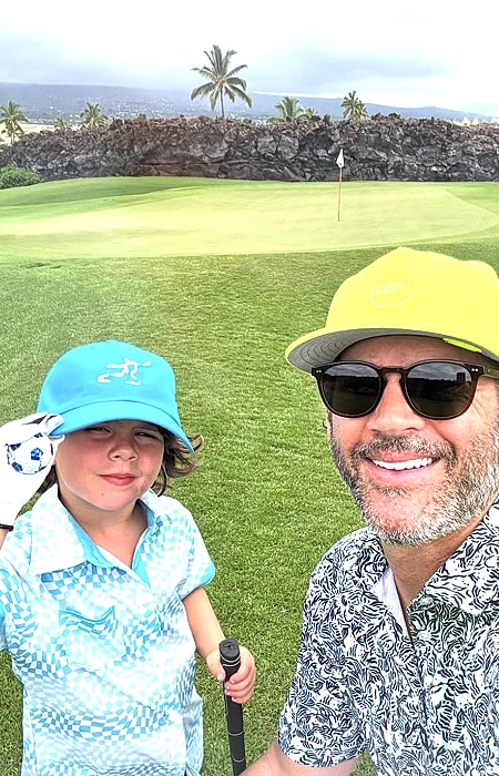Father and son enjoying a day golfing together.
