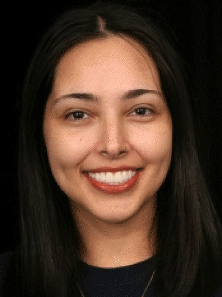 Smiling woman with long dark hair.