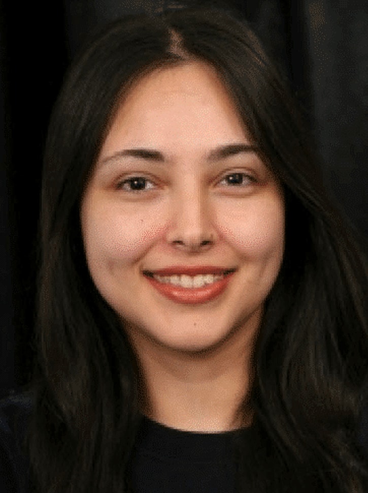 Smiling woman with long dark hair.
