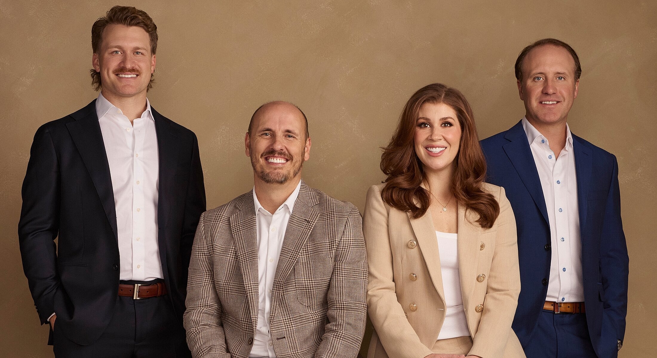 Professional group portrait of four individuals.