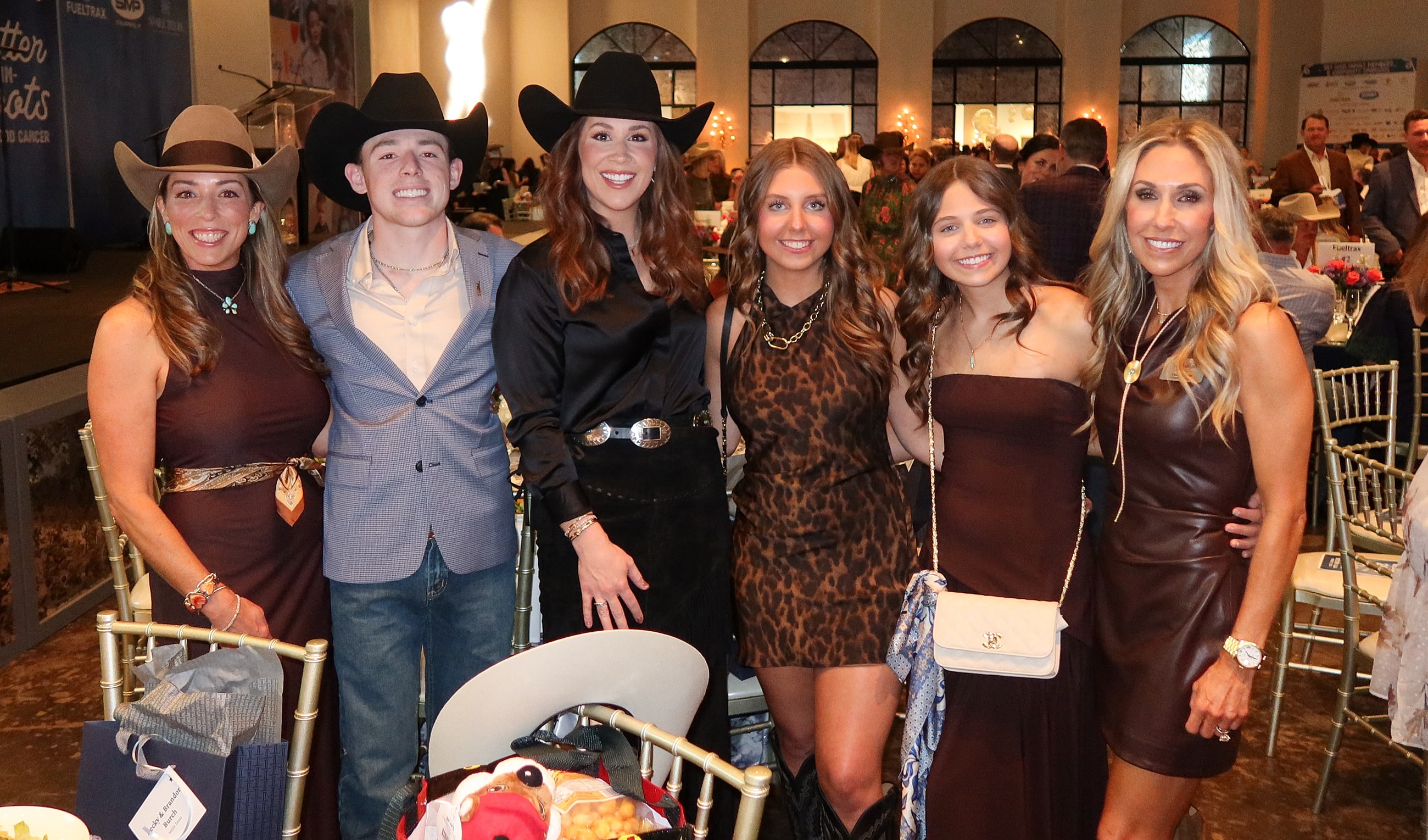 Group of people in western attire at event.