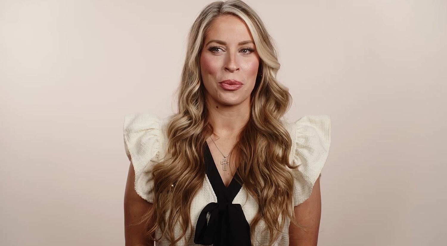Woman with long hair in a stylish outfit.